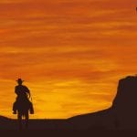cowboy riding into the sunset