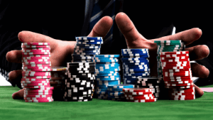 male hands holding stashes of poker chips