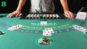 blackjack table with the dealer standing next to it