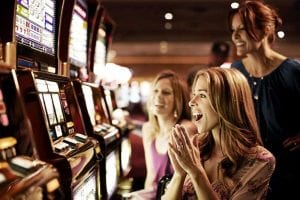 women cheering at slot machine