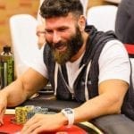 dan bilzerian playing poker on a poker table with poker chips near him